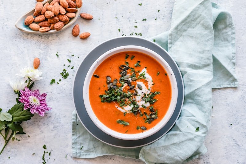Bowl of fresh vegetable soup with beans and kale for gut healing and weight loss meal plan
