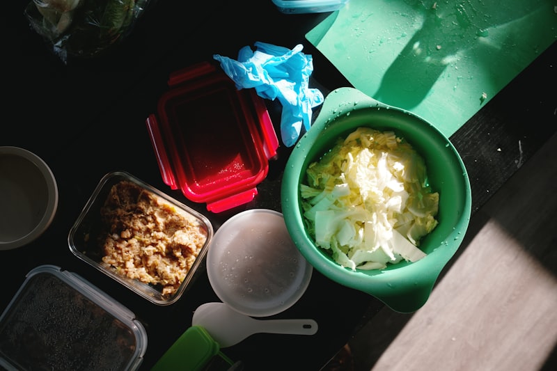 Overhead view of chopped vegetables rice and food containers prepared for weekly weight loss meal planning and portion control