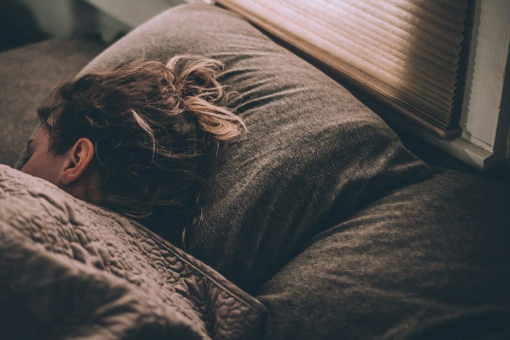 woman sleeping peacefully in bed after taking magnesium for better sleep